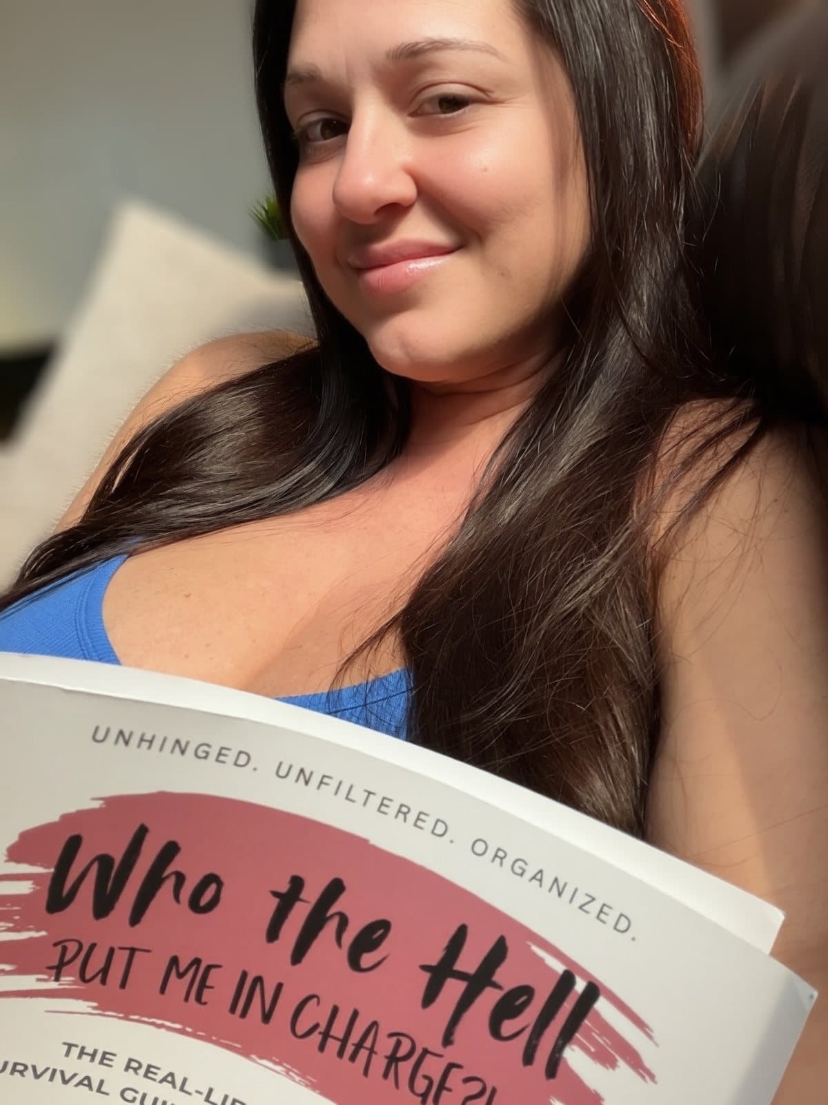 Stormi J holding her book, Who the Hell Put Me in Charge?!